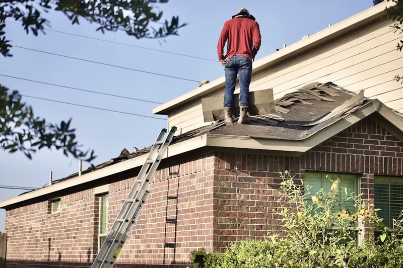Professional roofer working on a residential roof in South Park